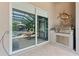 Outdoor kitchen area with built-in grill and a view of the pool area, offering seamless indoor-outdoor living at 1553 Canopy Oaks Blvd, Palm Harbor, FL 34683