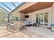 Well-appointed outdoor living area featuring a screened pool, built-in bar, and stylish seating at 1553 Canopy Oaks Blvd, Palm Harbor, FL 34683