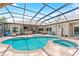 Stunning backyard pool area with a spa, outdoor bar, and plenty of space for entertaining at 1553 Canopy Oaks Blvd, Palm Harbor, FL 34683
