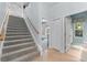 Carpeted staircase leads to the upper level, adjacent to bathroom and bedroom at 1553 Canopy Oaks Blvd, Palm Harbor, FL 34683