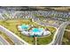 Extensive aerial view of the community, featuring a large pool, clubhouse, and amenities at 15825 Mauvewood Ave, Odessa, FL 33556