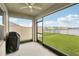 Screened porch with view of fenced back yard. Grill visible in background at 15825 Mauvewood Ave, Odessa, FL 33556