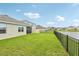 The backyard features a well-maintained lawn and a stunning view of the lake at 15825 Mauvewood Ave, Odessa, FL 33556