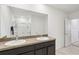 Bathroom featuring a double sink vanity and glass-enclosed shower at 15825 Mauvewood Ave, Odessa, FL 33556