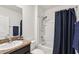 Bright bathroom featuring a shower-tub combo, granite countertop, and neutral color palette at 15825 Mauvewood Ave, Odessa, FL 33556