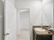 Neutral bathroom with granite countertop, undermount sink, and entry into another room at 15825 Mauvewood Ave, Odessa, FL 33556