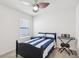 Bright bedroom with a ceiling fan, light and airy space with a musical keyboard at 15825 Mauvewood Ave, Odessa, FL 33556