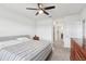 Large bedroom with a ceiling fan and view of a walkway and adjoining rooms at 15825 Mauvewood Ave, Odessa, FL 33556