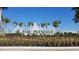 Beautifully landscaped entrance sign with fountain and lush flowerbeds at 15825 Mauvewood Ave, Odessa, FL 33556