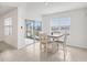 Sunny dining area with sliding glass doors to the patio and a view of the lake at 15825 Mauvewood Ave, Odessa, FL 33556