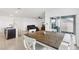 Bright dining area with a wooden table and white chairs, open to the living spaces at 15825 Mauvewood Ave, Odessa, FL 33556