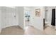 Bright entryway with tile floors leading to a bathroom and a room with a desk at 15825 Mauvewood Ave, Odessa, FL 33556