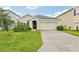 Charming single-story home with manicured lawn and inviting curb appeal on a sunny day at 15825 Mauvewood Ave, Odessa, FL 33556