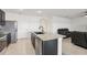 Modern kitchen featuring granite countertops, stainless steel appliances, and an island bar at 15825 Mauvewood Ave, Odessa, FL 33556