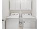 Convenient laundry room with white washer and dryer units at 15825 Mauvewood Ave, Odessa, FL 33556