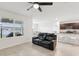 Open concept living area with reclining sofa and view of the kitchen and dining area at 15825 Mauvewood Ave, Odessa, FL 33556