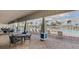 Covered outdoor seating area with tables and chairs overlooking a large pool at 15825 Mauvewood Ave, Odessa, FL 33556