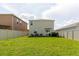 Spacious backyard with lush green grass and neutral-colored fencing at 17156 Yellow Pine St, Wimauma, FL 33598