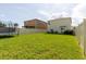 Spacious backyard featuring a well-maintained lawn, privacy fence, and outdoor seating area perfect for entertaining guests at 17156 Yellow Pine St, Wimauma, FL 33598