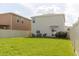 Large backyard with lush green grass and neutral-colored fencing at 17156 Yellow Pine St, Wimauma, FL 33598