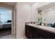 Bathroom featuring double sinks and granite countertops with access to the bedroom at 17156 Yellow Pine St, Wimauma, FL 33598
