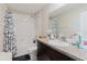 Bathroom featuring a shower/tub combo and dark wood vanity with granite countertops at 17156 Yellow Pine St, Wimauma, FL 33598