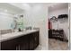 Bathroom featuring double sinks, granite countertops and a walk in closet at 17156 Yellow Pine St, Wimauma, FL 33598