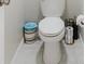 Bathroom featuring a white toilet with decorative trash can and toilet paper holder at 17156 Yellow Pine St, Wimauma, FL 33598