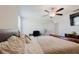 Bedroom with ceiling fan, carpet, an attached desk, a queen-sized sleigh bed and lots of natural light at 17156 Yellow Pine St, Wimauma, FL 33598