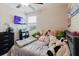Bedroom with ceiling fan, a bed covered in stuffed animals and TV at 17156 Yellow Pine St, Wimauma, FL 33598