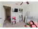 Bedroom with ceiling fan, closet, tv and bunk beds laying on ground at 17156 Yellow Pine St, Wimauma, FL 33598
