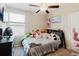 Cozy bedroom featuring a ceiling fan, window, and comfortable bed at 17156 Yellow Pine St, Wimauma, FL 33598