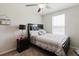 Bedroom featuring a ceiling fan, a window, and dark wood furniture at 17156 Yellow Pine St, Wimauma, FL 33598