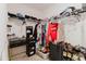 Walk-in closet with black shelving, desk, clothing, luggage, and shoes at 17156 Yellow Pine St, Wimauma, FL 33598