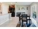 Dining area with dark wood table and chairs, flowing into the kitchen and living area at 17156 Yellow Pine St, Wimauma, FL 33598
