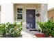 Charming front door with a floral wreath, surrounded by lush greenery and manicured landscaping at 17156 Yellow Pine St, Wimauma, FL 33598
