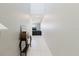 Bright hallway with tile flooring and neutral walls, leading to the living areas of the home at 17156 Yellow Pine St, Wimauma, FL 33598