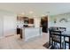 Open kitchen with dark cabinets, granite countertops, stainless steel appliances, and a center island at 17156 Yellow Pine St, Wimauma, FL 33598