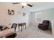 Upstairs loft space, featuring carpet, and a dark brown reclining chair, with artwork adorning the light grey walls at 17156 Yellow Pine St, Wimauma, FL 33598