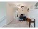 Upstairs loft area with carpet, a ceiling fan, a desk and chair, and lots of natural light at 17156 Yellow Pine St, Wimauma, FL 33598