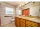 Bathroom showcasing a granite countertop vanity, neutral walls, and decorative lighting at 17807 Fallowfield Dr, Lutz, FL 33549