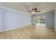 Spacious bedroom featuring tile floors, ceiling fan, and a sliding glass door to the pool area at 17807 Fallowfield Dr, Lutz, FL 33549
