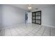 Bedroom featuring tile flooring and a glass paneled closet at 17807 Fallowfield Dr, Lutz, FL 33549