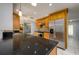Modern kitchen with granite countertops and stainless steel appliances, connecting to the dining area at 17807 Fallowfield Dr, Lutz, FL 33549