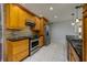 Well-equipped kitchen with stainless steel appliances, granite countertops, and tile backsplash at 17807 Fallowfield Dr, Lutz, FL 33549