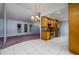 View of the living room and kitchen featuring stainless steel appliances and a decorative light fixture at 17807 Fallowfield Dr, Lutz, FL 33549