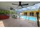 Backyard with a screened in pool, spa, and patio at 17807 Fallowfield Dr, Lutz, FL 33549