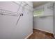 Walk-in closet with shelving offering ample storage and a frosted glass window at 17807 Fallowfield Dr, Lutz, FL 33549