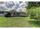 Exterior view of home and large green yard at 1868 Lombardy Dr, Clearwater, FL 33755
