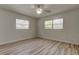 Bright bedroom featuring a ceiling fan, neutral paint, wood-look flooring, and a window with blinds at 1868 Lombardy Dr, Clearwater, FL 33755